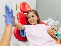 Child high-fives dentist
