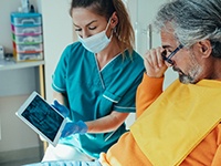 a patient visiting his dentist in Dallas for a dental implant consultation