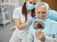 a patient smiling after receiving his dental implants in Dallas