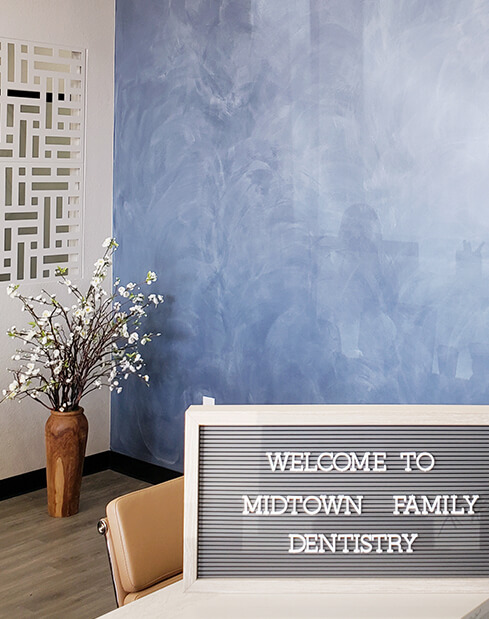 Welcome to Midtown Family Dentistry of Dallas sign on dental office reception desk