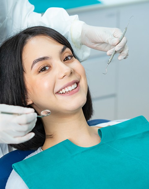 Happy female dental patient undergoing a checkup