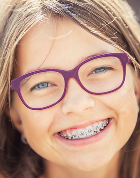 A young girl wearing braces