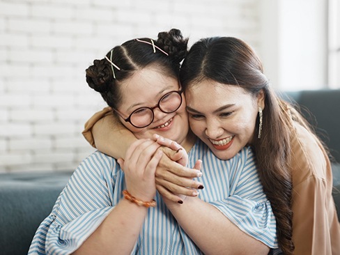 woman hugging special needs child 