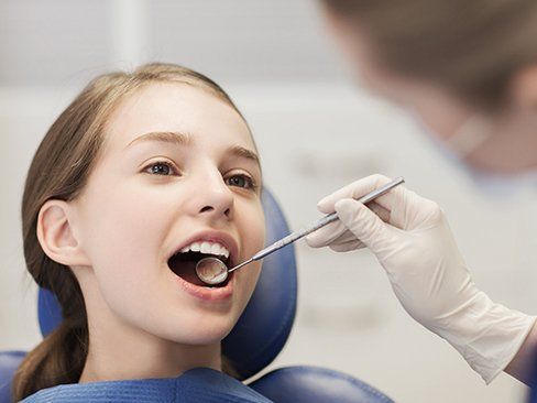 Child receiving exam after tooth colored fillings