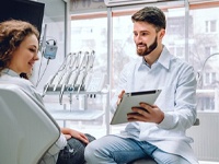 dentist showing a tablet to a patient