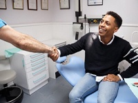 man shaking hands with his dentist