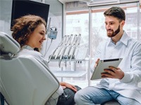 dentist showing a tablet to a patient