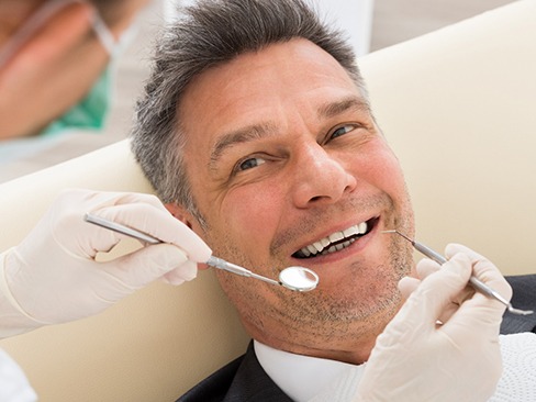 Man at dentist in Dallas having dental crown placed