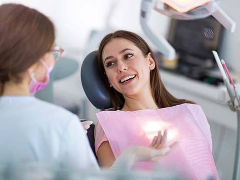 Woman visiting an emergency dentist in Dallas