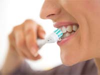 closeup of person brushing teeth
