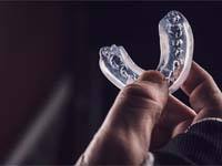 athlete holding a mouthguard