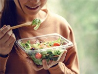 Close-up of a woman eating a salad