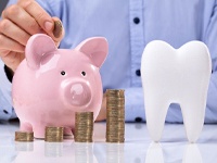 tooth and piggy bank for dental implants in Dallas