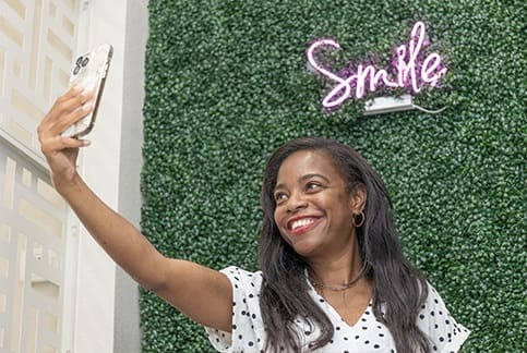 Woman taking selfie in Dallas dental office