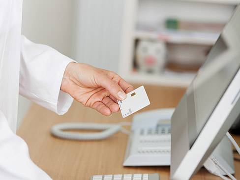 Team member entering dental insurance information into computer