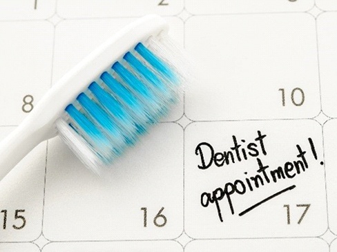 Toothbrush and dental appointment on calendar