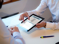 An insurance agent discussing dental insurance with a patient