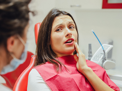 A patient talking to her dentist about root canal therapy