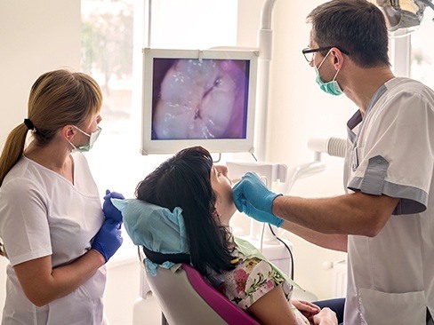 Dentist and patient looking at intraoral images
