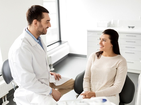 Woman smiling at dental office for teeth whitening in Dallas