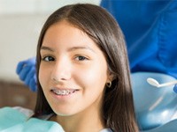 Teen girl smiling with traditional braces
