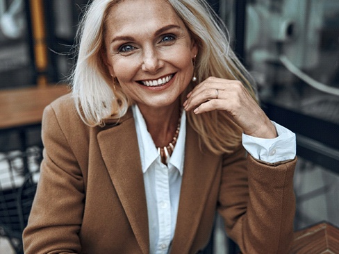 Woman at café smiling with veneers in Dallas