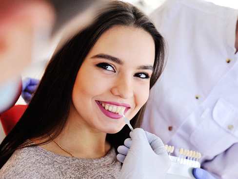 woman smiling about getting veneers in Dallas