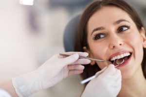 Smiling woman getting a dental exam