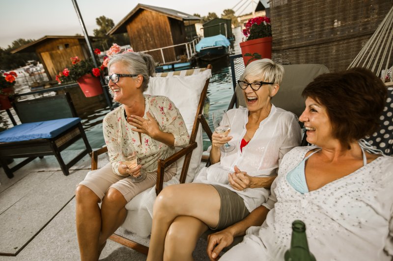 Group of women with dental implants in Dallas smiling outside