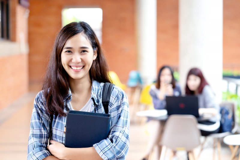 student smiling before a dental exam in Dallas