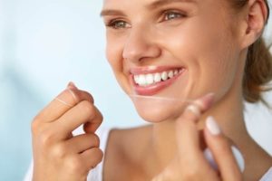 a patient flossing their teeth 