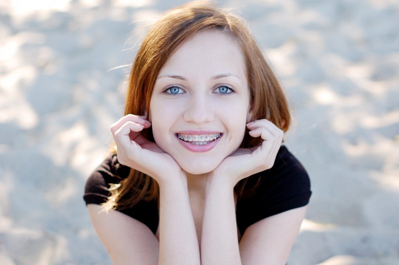 A pretty and smiling girl showing her braces
