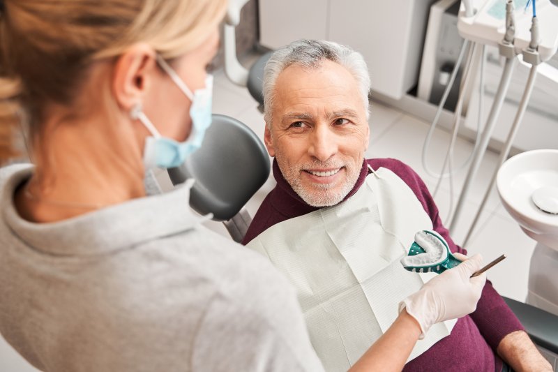 An older man at the dentist about to have his dentures relined.