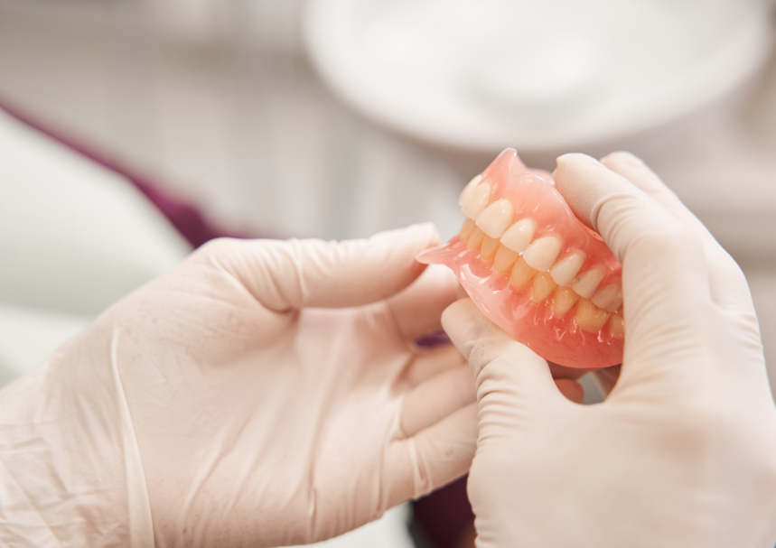 Dentist holding dentures